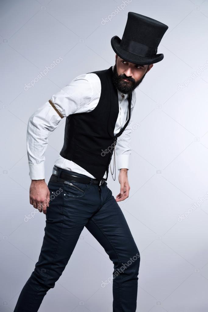 Retro hipster 1900 fashion man with black hair and beard. Wearin