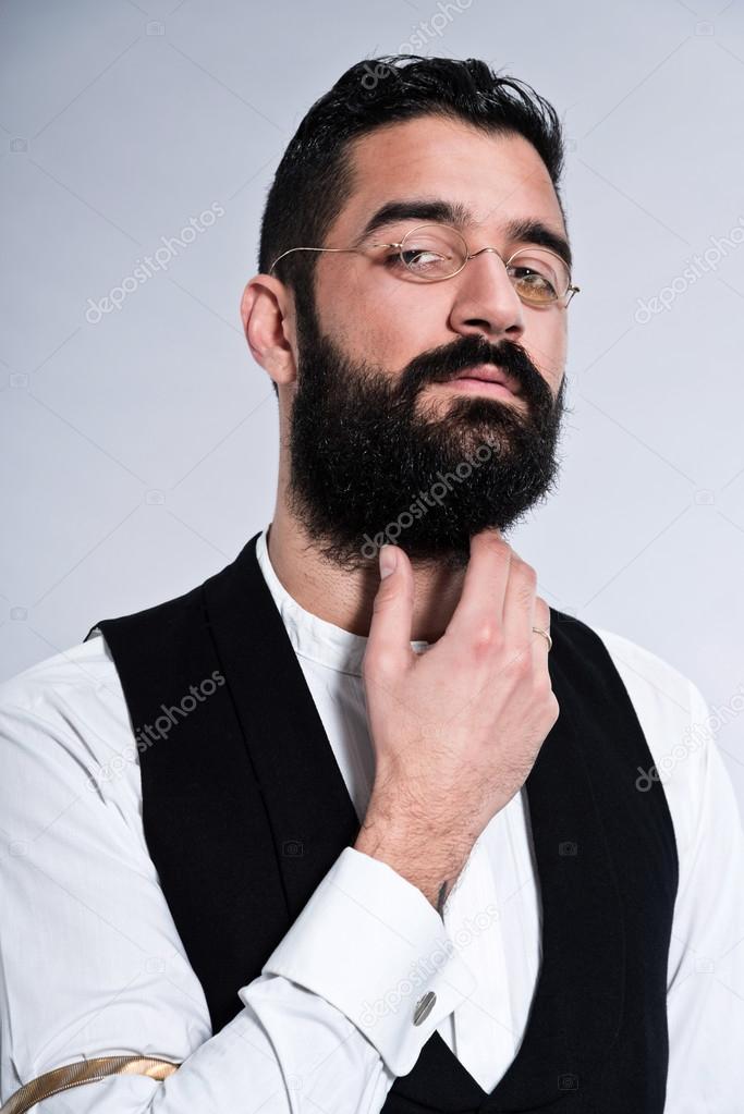 Retro hipster 1900 fashion man with black hair and beard. Wearin