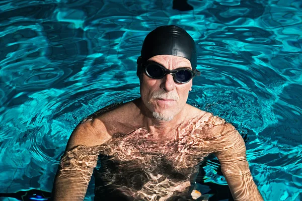 Active healthy senior man with beard in swimming pool wearing bl — Stock Photo, Image