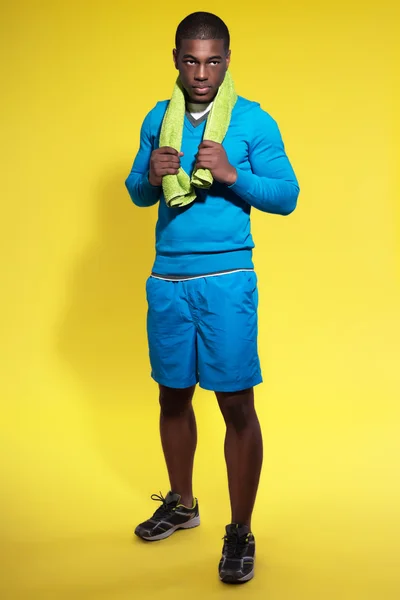 Athletic black man in sportswear fashion. Runner with towel. Int — Stock Photo, Image