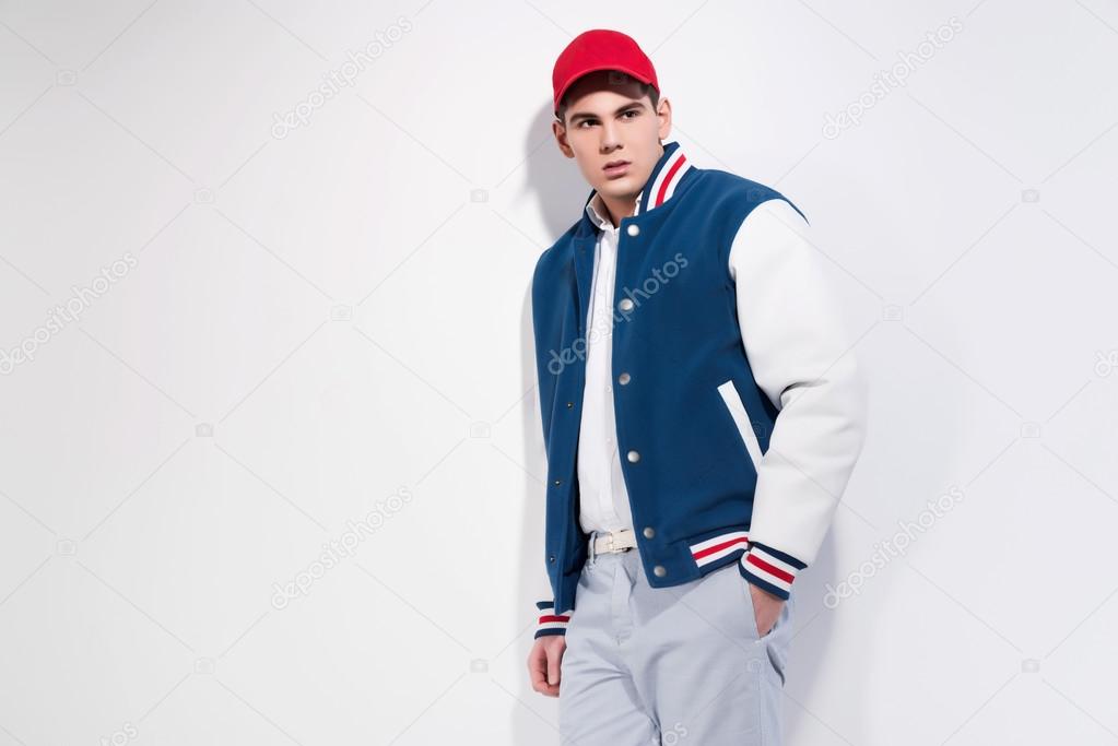 Retro fifties sportive fashion man wearing blue baseball jacket 
