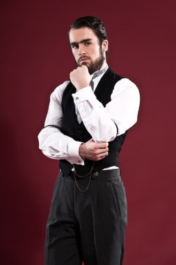 Retro 1900 victorian fashion man with beard wearing black gilet 