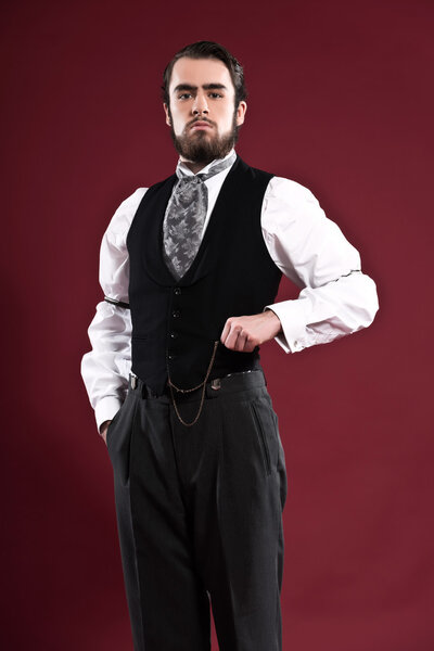 Retro 1900 victorian fashion man with beard wearing black gilet 