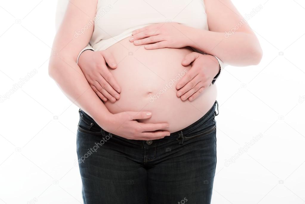 Hands of man and woman holding pregnancy belly of future mom. Is
