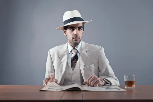 Mafia fashion man wearing white striped suit and hat. Sitting at — Stock Photo, Image