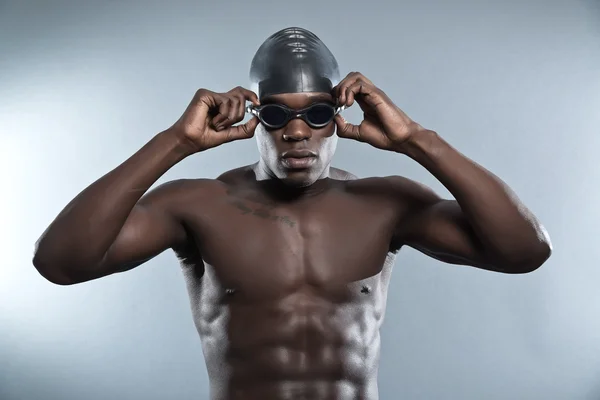 Athletic muscled black african swimmer wearing protective glasse — Stock Photo, Image