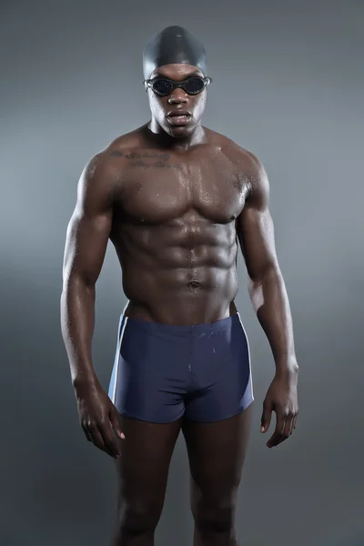 Athletic muscled black african swimmer wearing protective glasse — Stock Photo, Image