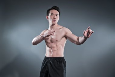 kaslı Asya kung fu adam aksiyon poz. siyah pantalon giyiyor. s
