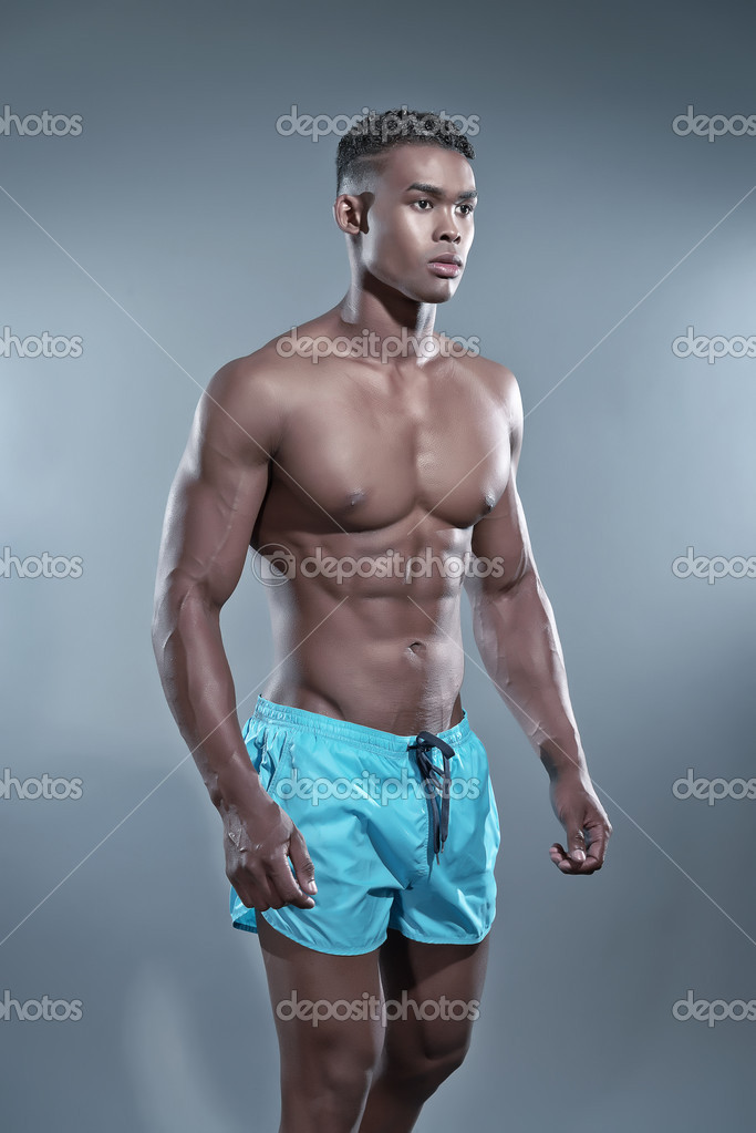 Fitness black african man wearing blue shorts. Swimwear fashion. Stock