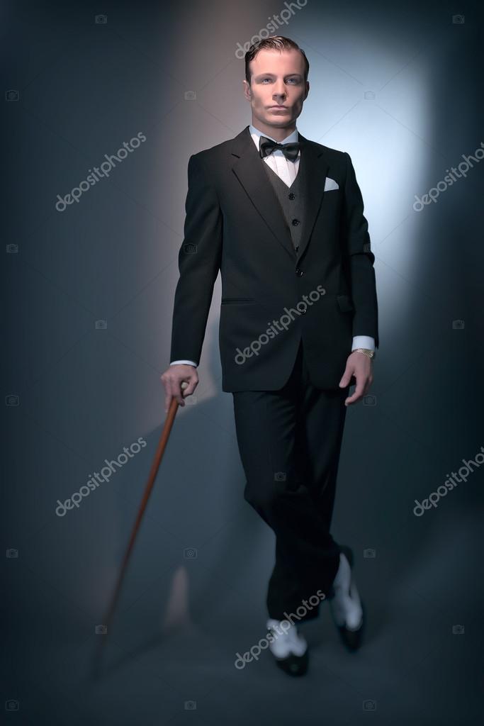 Retro 1920 business fashion man wearing black suit and bow tie. Stock Photo  by ©ysbrand 48617485