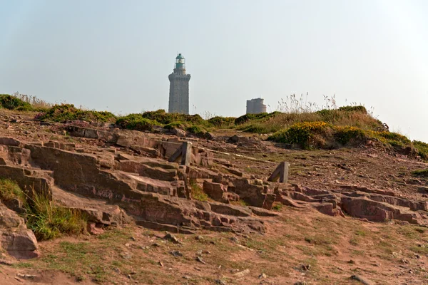 Rocks with lighthouse at the Cape of Frehel. Bretagne. France. — Stock Photo, Image
