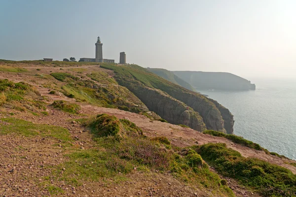Cliffs with old tower at the Cape of Frehel. Brittany. France. — Stock Photo, Image