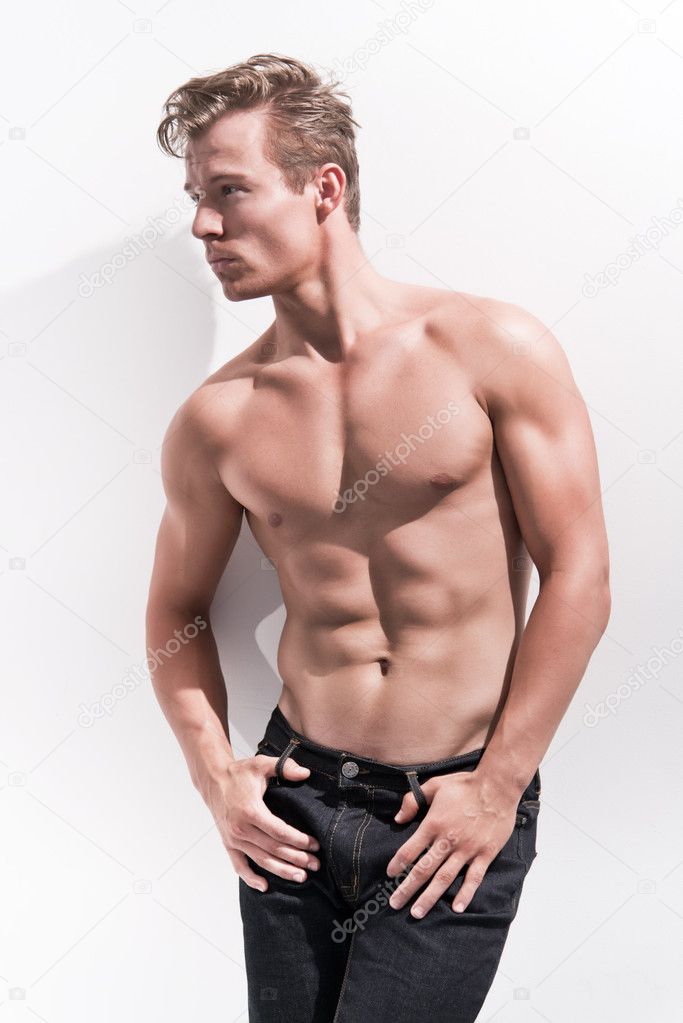 Male fitness model wearing blue jeans. Blonde hair. Against whit Stock  Photo by ©ysbrand 51428573