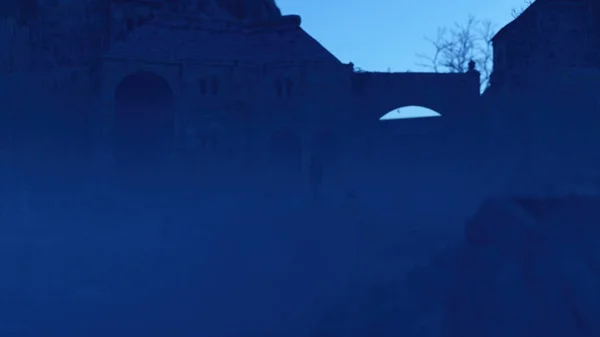 Homem Capuz Caminha Sobre Uma Ponte Antigo Castelo Nebuloso Anoitecer — Fotografia de Stock