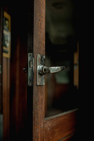 Open door in an interior of a vintage train compartment.