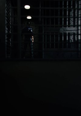 Prisoner behind bars. 3D render.