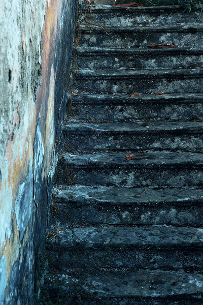 Weathered concrete stairway near an exterior wall.