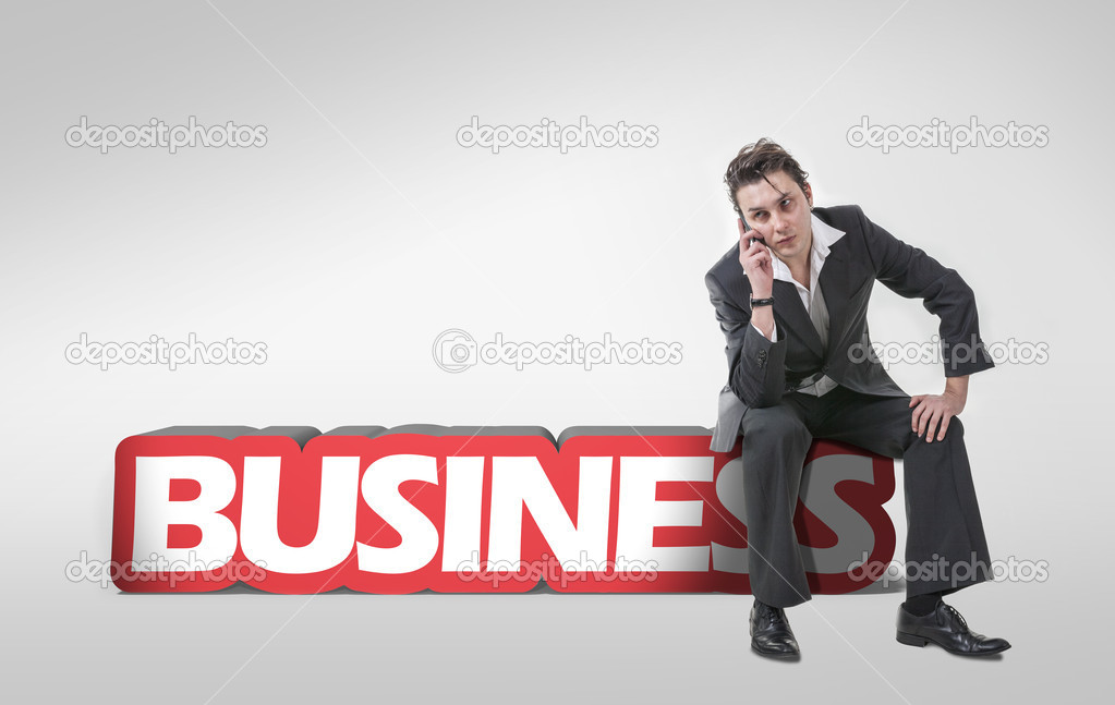 Young businessman using a mobile phone and sitting on 3d text