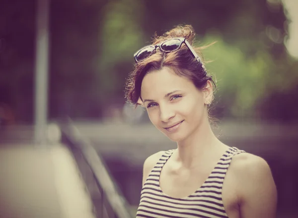 Stylized instagram colorized vintage fashion portrait of a young sexy woman wearing sunglasses with beauty bokeh — Stock Photo, Image