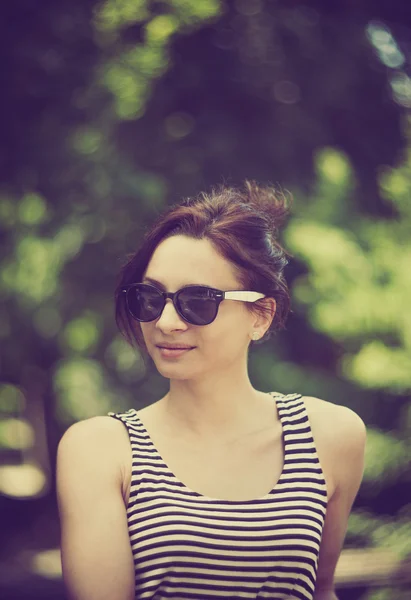 Stylized instagram colorized vintage fashion portrait of a young sexy woman wearing sunglasses with beauty bokeh — Stock Photo, Image