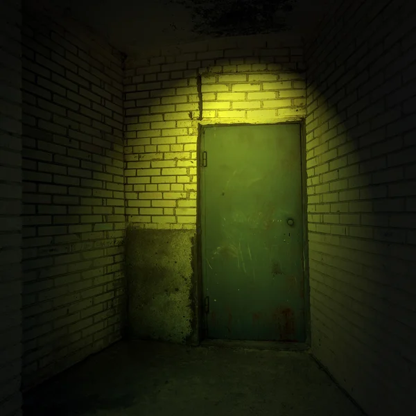 Metal door in a ray of light at night — Stock Photo, Image