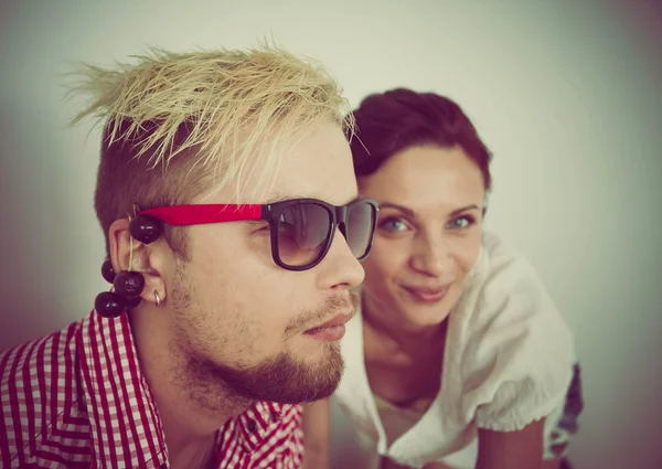 Stylized instagram colorized vintage fashion portrait of a young sexy woman and a young handsome man — Stock Photo, Image