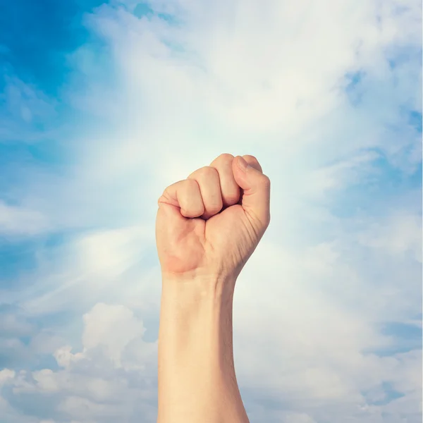 A clenched fist held high in protest — Stock Photo, Image