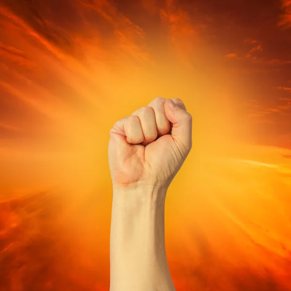 A clenched fist held high in protest — Stock Photo, Image