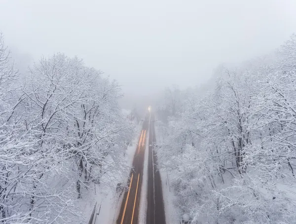 Snowstorm, slick roads and lots of traffic in evening city — Stock Photo, Image