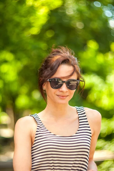 Fashion portrait of a young sexy woman wearing sunglasses with beauty bokeh Stock Picture