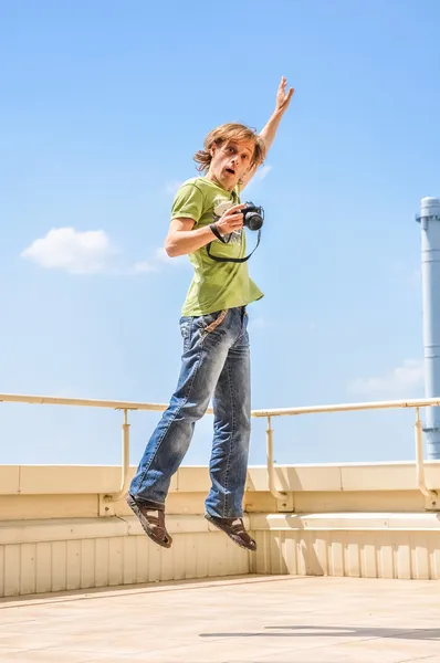 Crazy cheerful photographer in jump — Stock Photo, Image