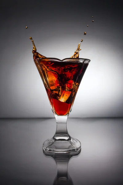Glass with whiskey splash — Stock Photo, Image