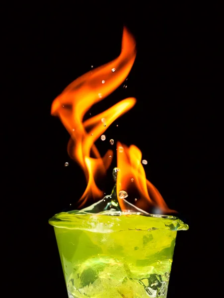 Glass with mojito splash and fire on black background — Stock Photo, Image