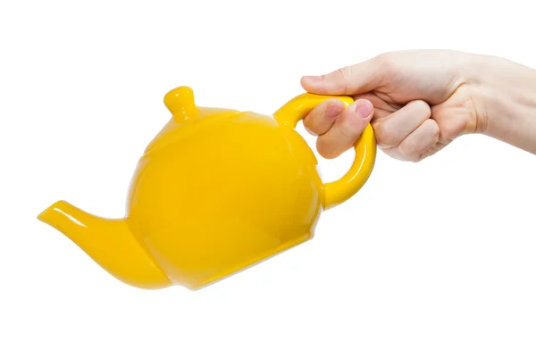 Yellow teapot isolated in hand on white background and clipping path — Stock Photo, Image