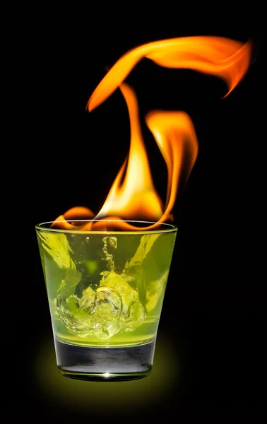 Glass with mojito splash and fire on black background — Stock Photo, Image