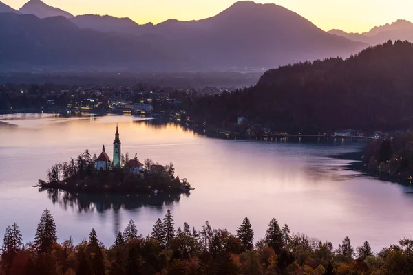 Der ikonische Bleder See mit der Marienkirche und den Bergen vor dem kühlen herbstlichen Morgenhimmel, Slowenien, Europa. — Stockfoto