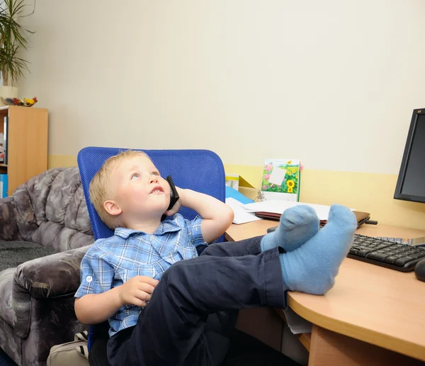 Cute boy in office with calculator — Stock Photo, Image