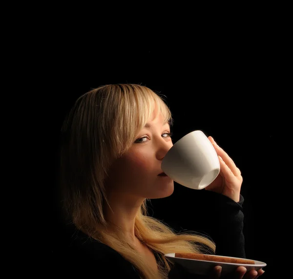 Young blond hair woman with coffe on a dark background — Stock Photo, Image