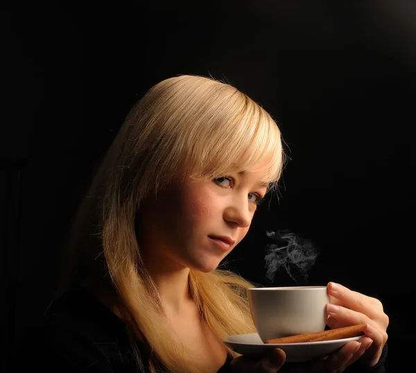 Young blond hair woman with coffe on a dark background — Stock Photo, Image