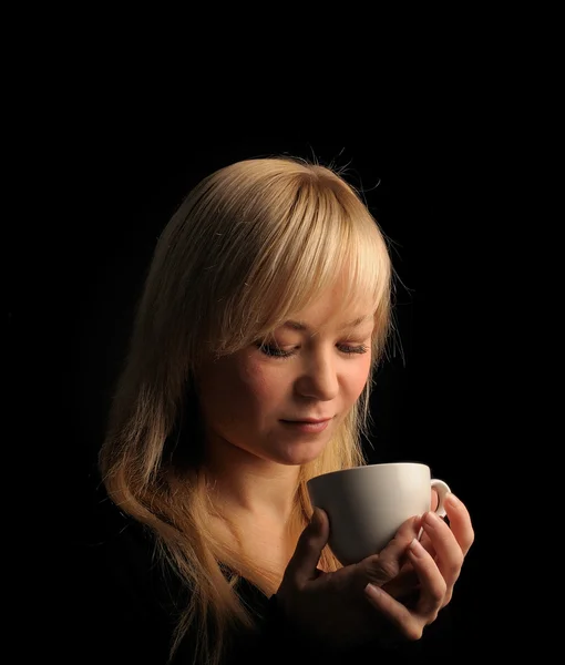 Young blond hair woman with coffe on a dark background — Stock Photo, Image