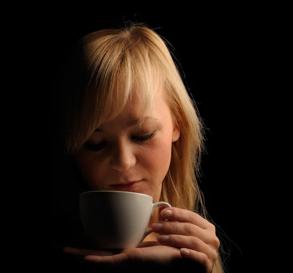 Young blond hair woman with coffe on a dark background — Stock Photo, Image