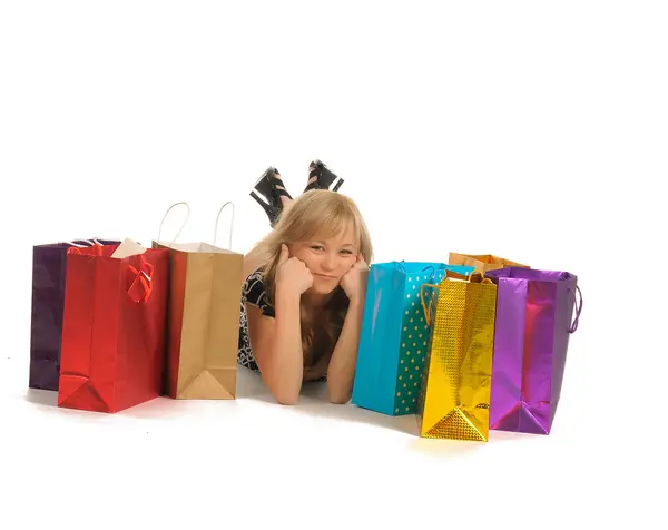 Mulher bonita com um monte de sacos de compras. isolado em branco — Fotografia de Stock