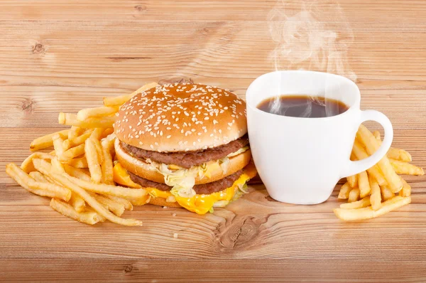 Set petit déjeuner : café, hamburger et frites sur fond bois — Photo