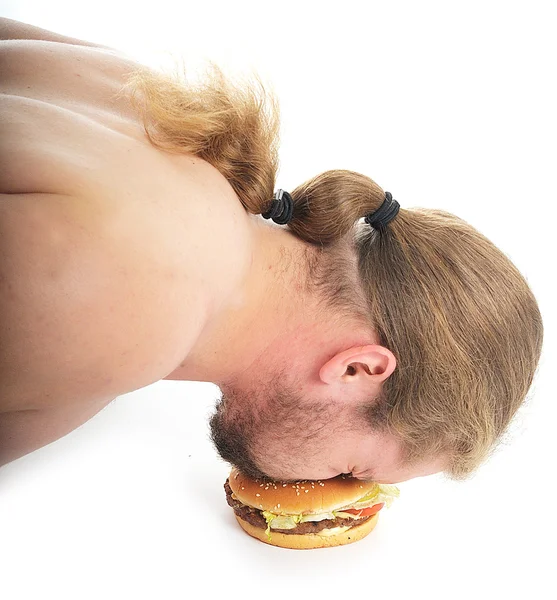 Man geduwd van de vloer en proberen te eten van een hamburger — Stockfoto