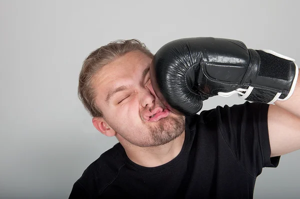 Man getting punch of a boxing gloves — Stock Photo, Image