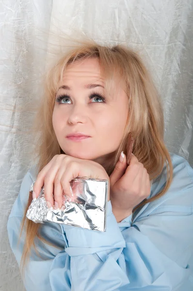 Beauty woman in man shirt is eating chocolate — Stock Photo, Image