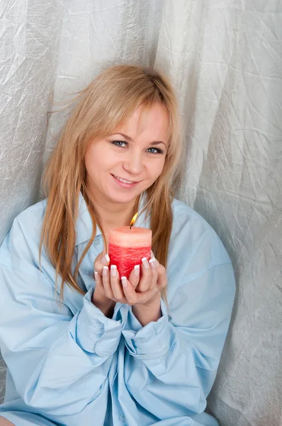 Woman in man shirt with candle in hands — Stock Photo, Image