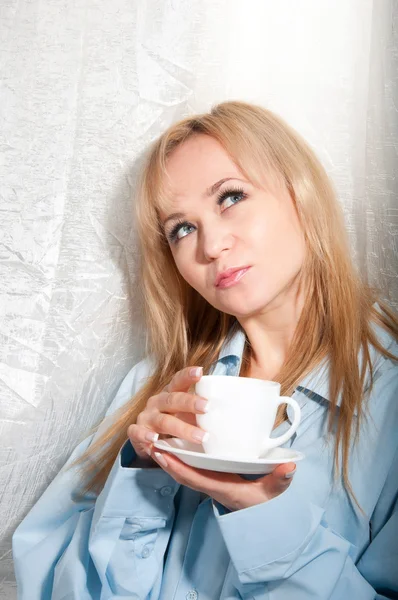 Alluring sexy woman in man boyfriend shirt at home with coffee at morning. — Stock Photo, Image