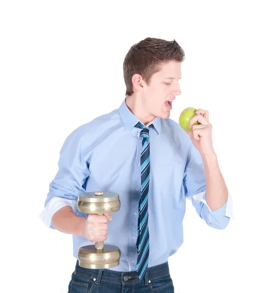 Joven hombre de negocios con mancuerna comiendo manzana verde — Foto de Stock