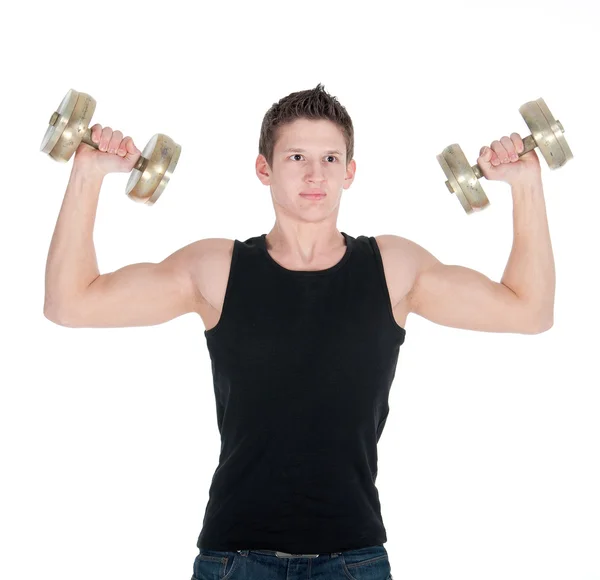 Portrait of a healthy young man doing exercise with dumbbell against white background — Stock Photo, Image
